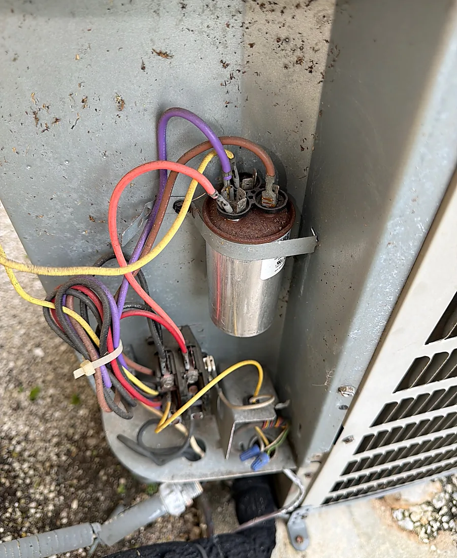 Failed AC capacitor being replaced with wiring exposed