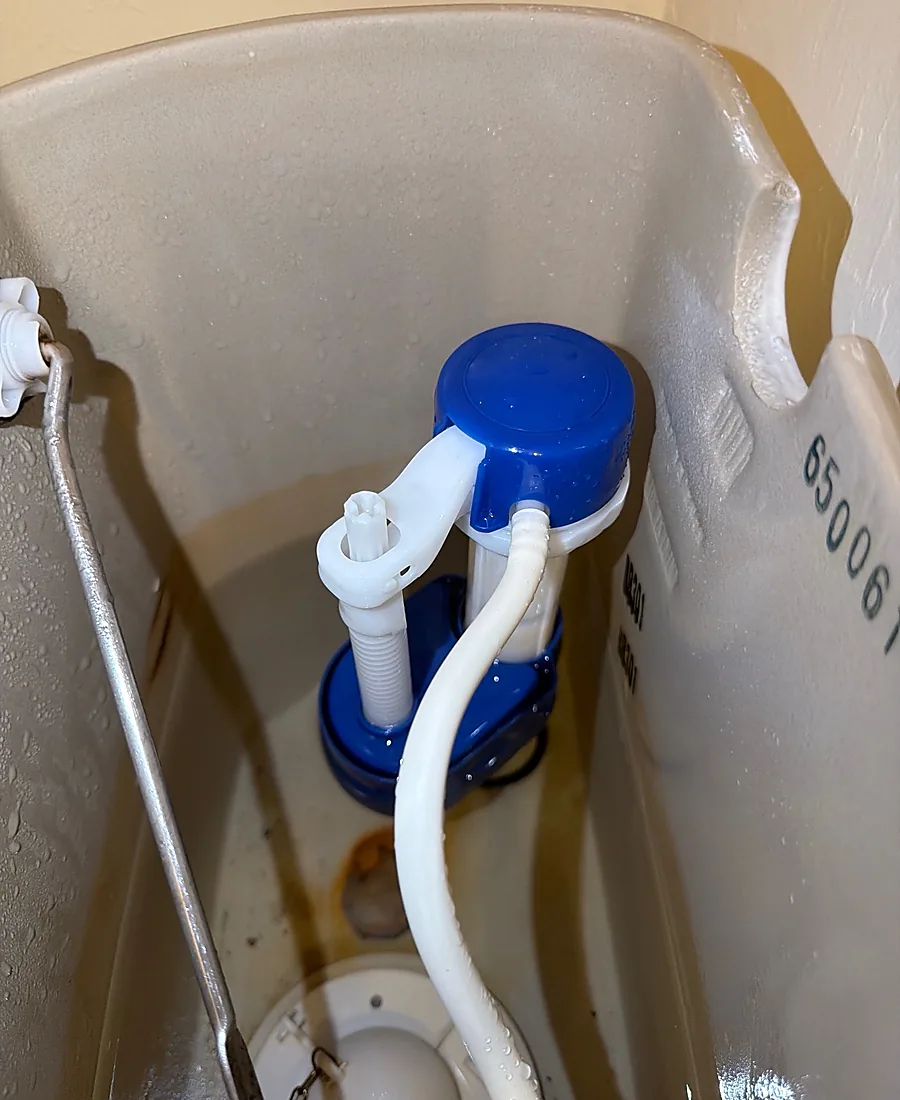 New fill valve installed cleanly inside the toilet tank